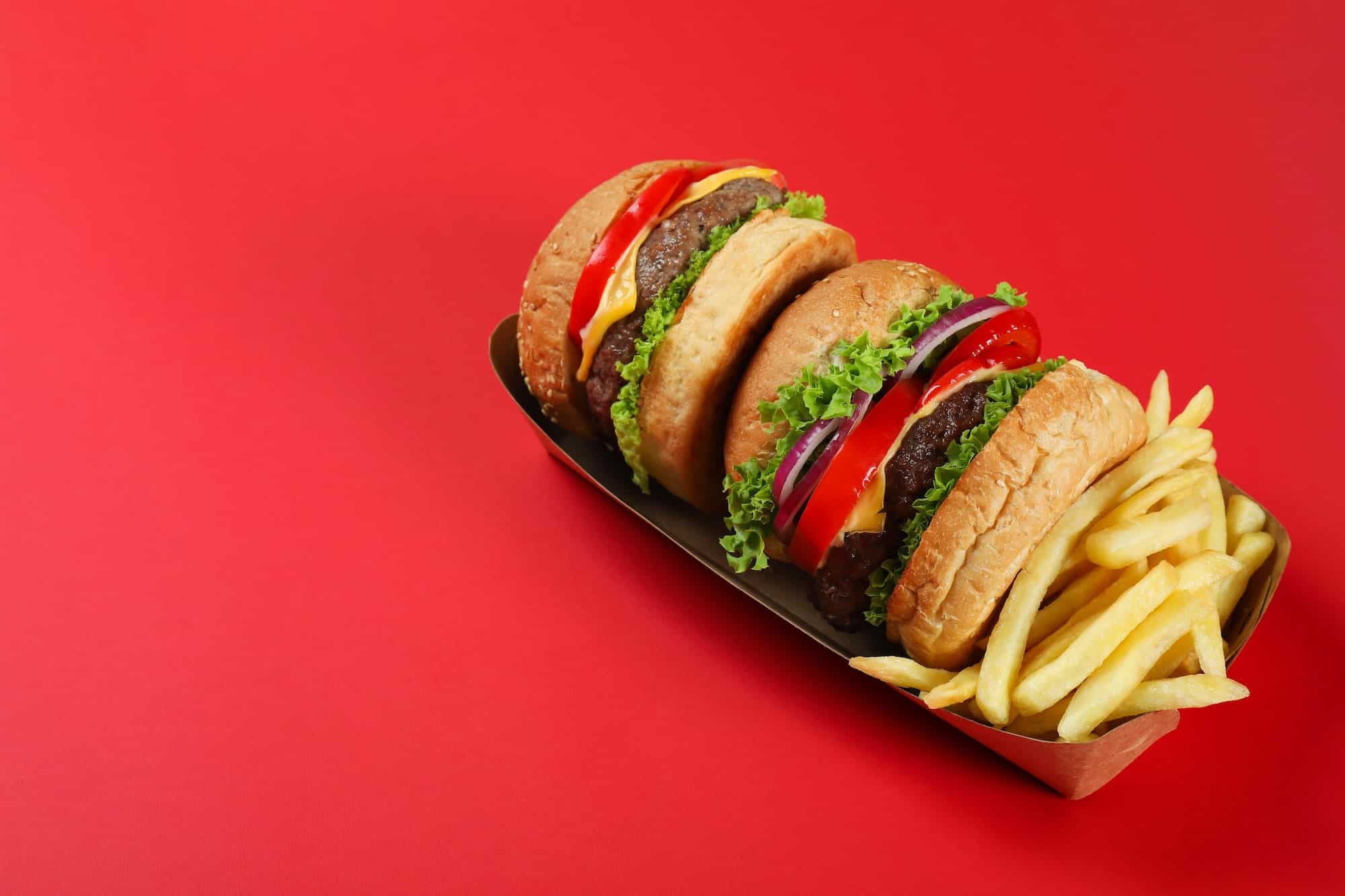 https://impactful.news/wp-content/uploads/2023/04/concept-of-fast-food-on-red-background.jpg